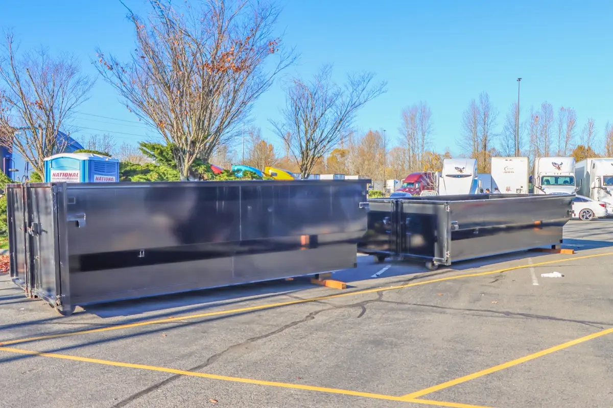 Professional dumpster rental service with roll-off container on residential driveway in Buckingham